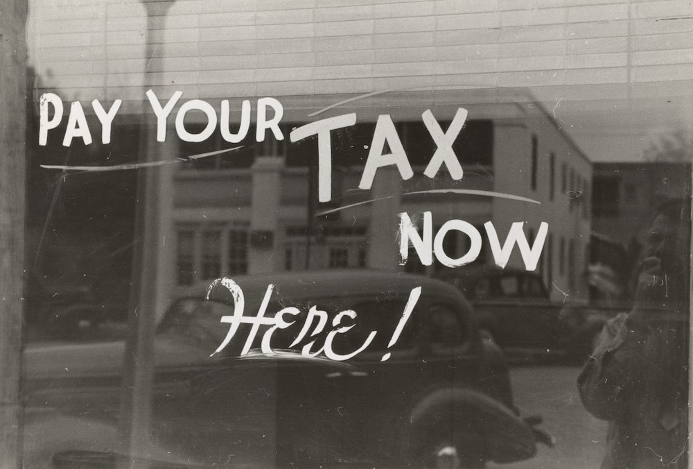 tax slogan written on shop window